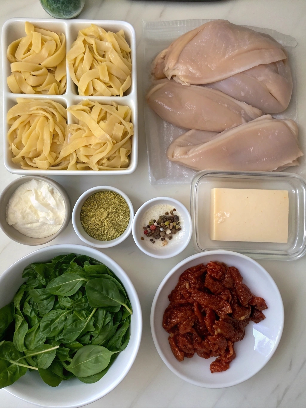 tuscan chicken casserole ingredients laid out on k