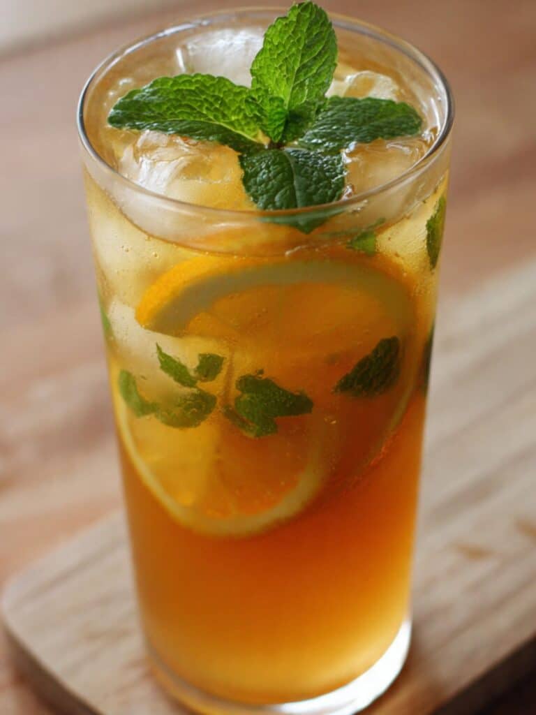 Starbucks honey citrus mint tea in glass mug with lemon and steam