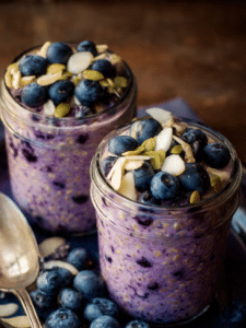 Blueberry overnight oats in a jar topped with fresh blueberries