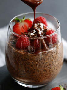 Chocolate overnight oats in a glass jar topped with banana and chia seeds